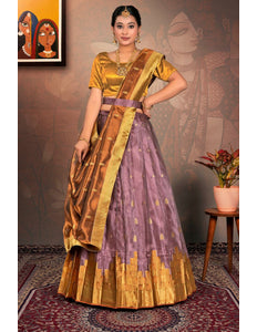 Woman wearing a traditional gold and purple lehenga choli and dupatta
