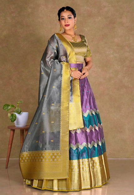 Woman wearing a traditional half saree with a multicolor design