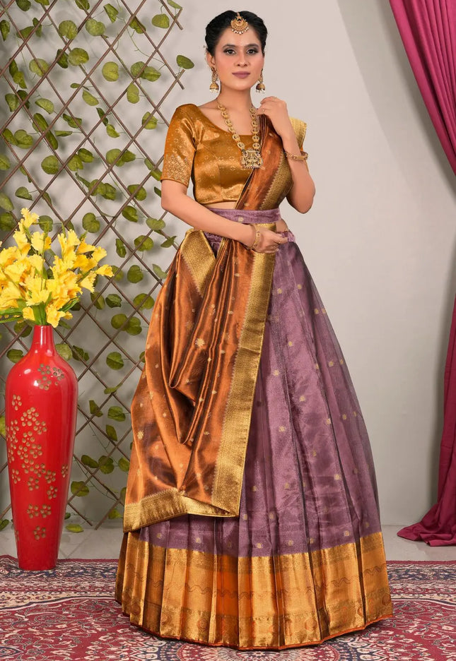 Woman in a traditional gold and purple lehenga choli with dupatta
