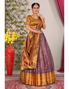 Woman in a traditional gold and purple lehenga choli with dupatta