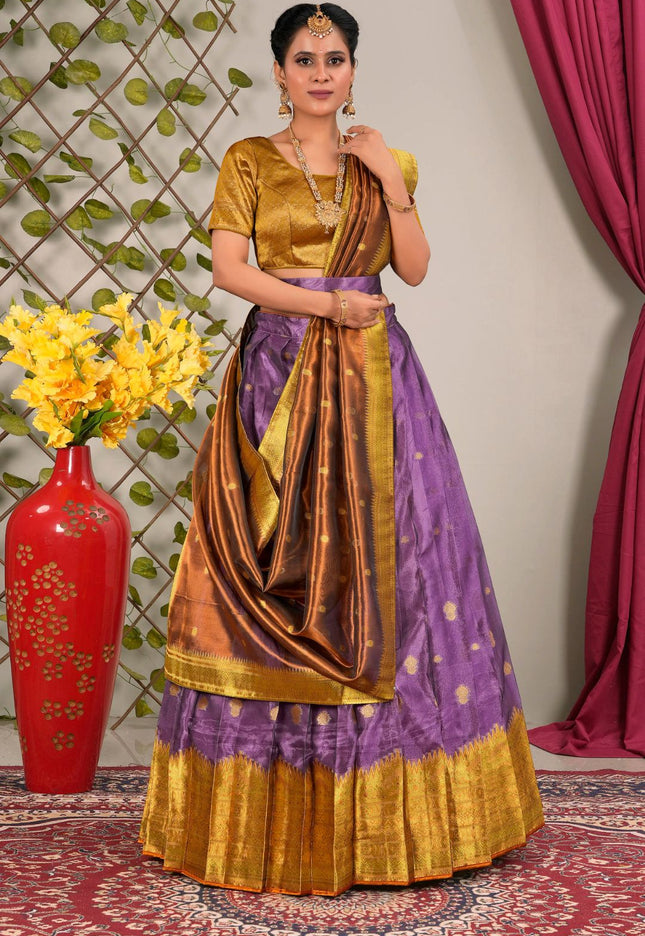 Woman in a traditional purple and gold lehenga choli with dupatta