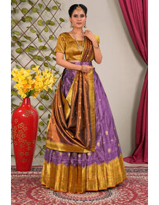 Woman in a traditional purple and gold lehenga choli with dupatta
