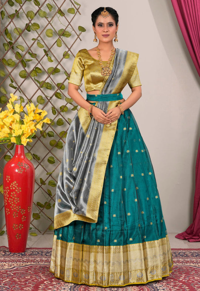 Woman wearing a traditional green and gold lehenga choli