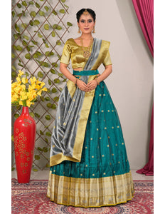 Woman wearing a traditional green and gold lehenga choli
