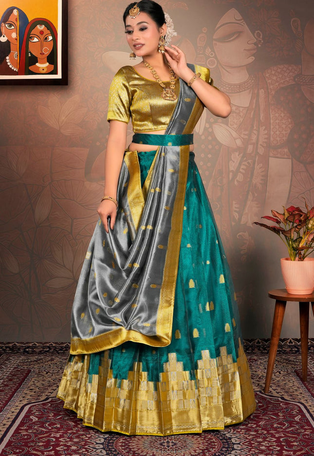 Woman in a traditional outfit with gold, green, and gray colors