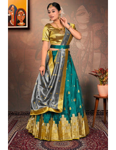 Woman in a traditional outfit with gold, green, and gray colors