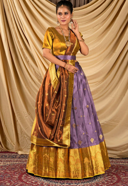 Woman wearing a traditional gold and purple lehenga choli with dupatta