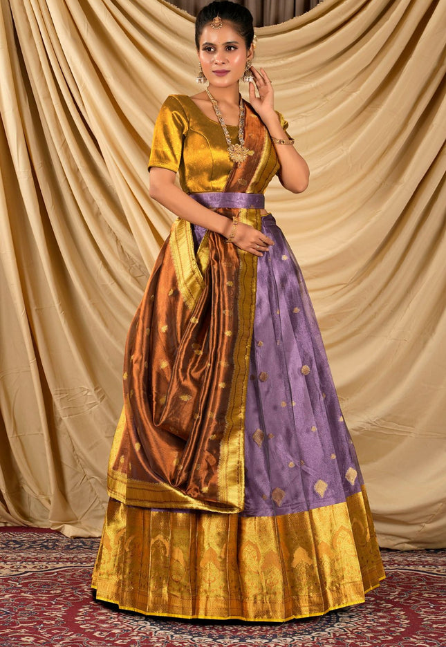 Woman wearing a traditional gold and purple lehenga choli with dupatta