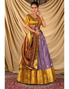 Woman wearing a traditional gold and purple lehenga choli with dupatta