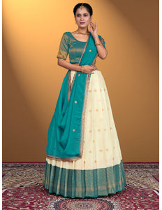 Woman wearing a teal and cream lehenga choli