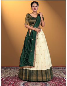 Woman wearing a green and cream traditional outfit