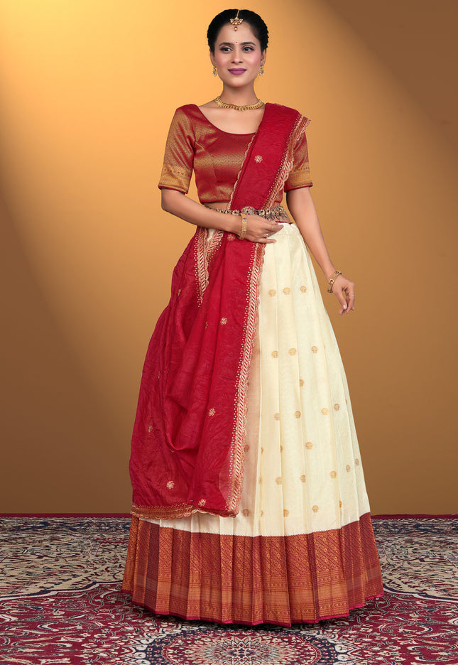 Woman wearing a cream lehenga choli with a Maroon blouse