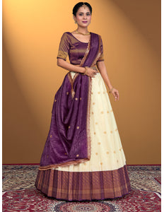Woman wearing a traditional purple and white lehenga choli