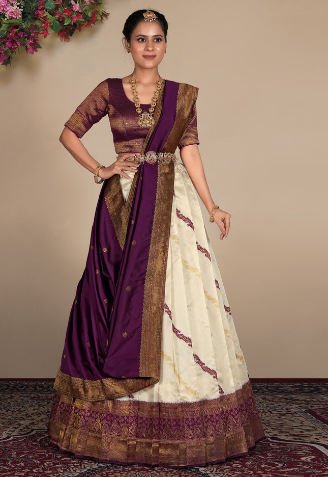 Woman wearing a traditional lehenga choli with a purple and white design