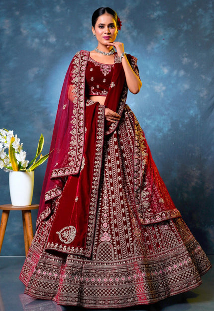 Woman wearing a traditional maroon embroidered lehenga choli with dupatta