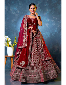 Woman wearing a traditional maroon embroidered lehenga choli with dupatta