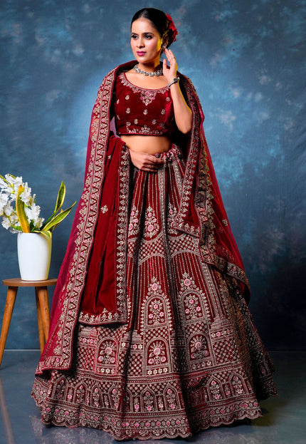 Woman in a traditional maroon embroidered lehenga choli with dupatta