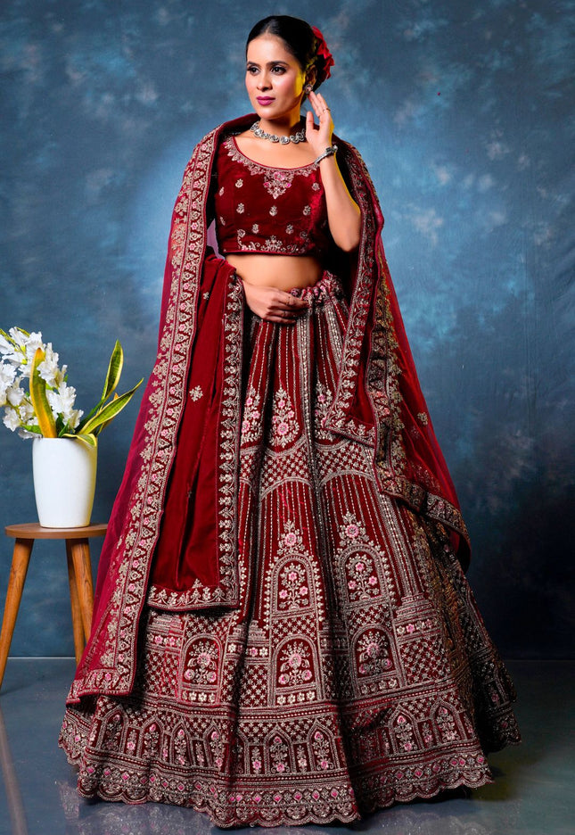 Woman in a traditional maroon embroidered lehenga choli with dupatta