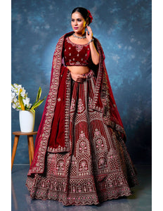 Woman in a traditional maroon embroidered lehenga choli with dupatta