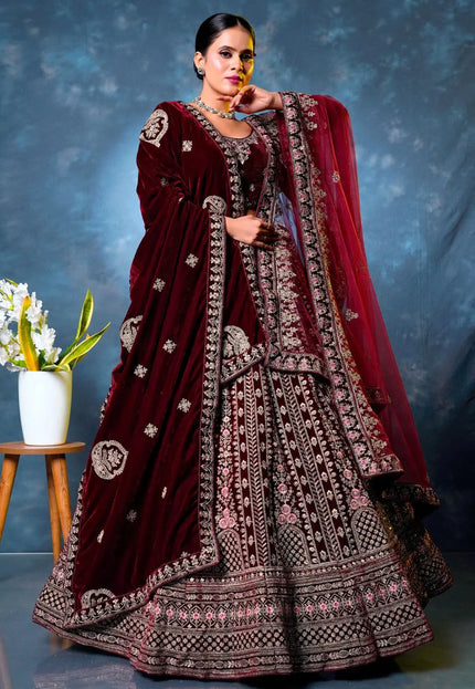 Woman wearing a maroon embroidered traditional lehenga choli with dupatta