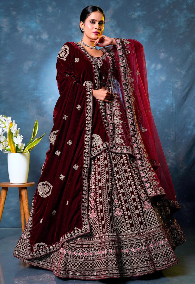 Woman wearing a maroon embroidered traditional lehenga choli with dupatta