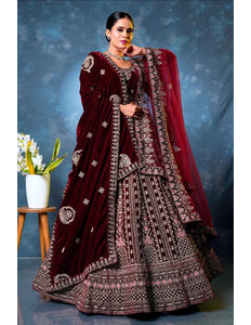 Woman wearing a maroon embroidered traditional lehenga choli with dupatta