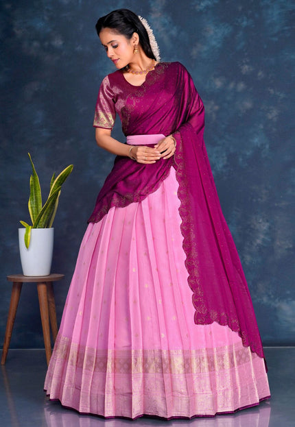 Woman wearing a pink and purple lehenga choli with dupatta