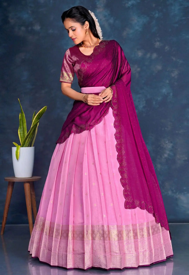 Woman wearing a pink and purple lehenga choli with dupatta