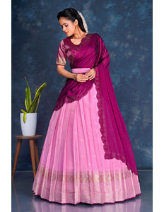 Woman wearing a pink and purple lehenga choli with dupatta