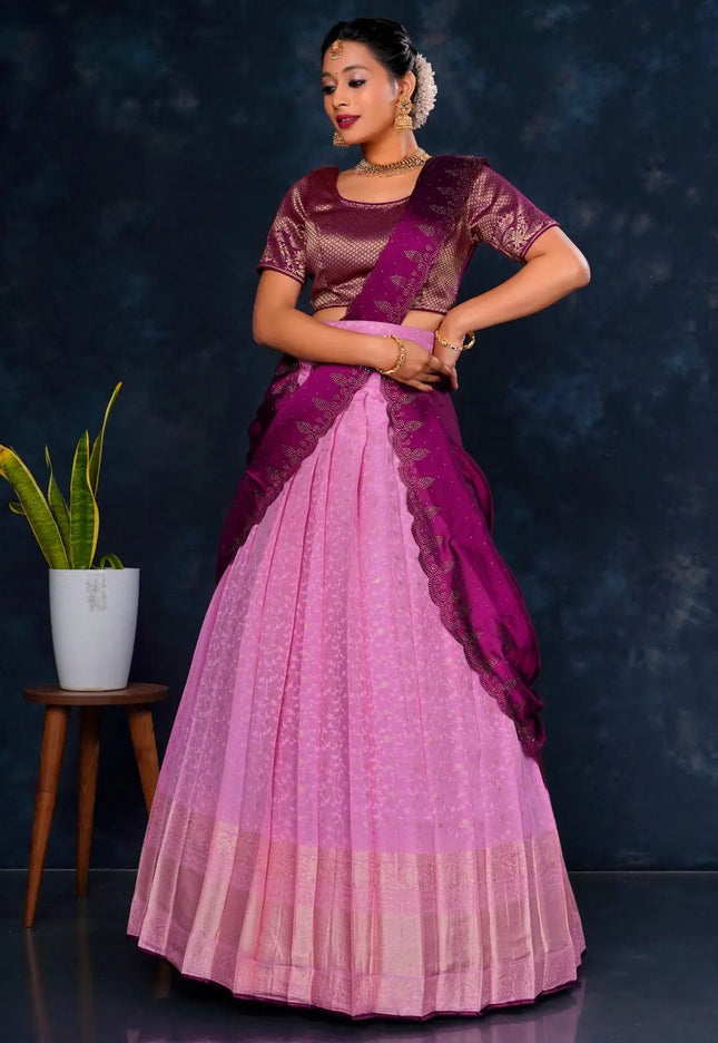 Woman wearing a pink and purple lehenga choli with dupatta