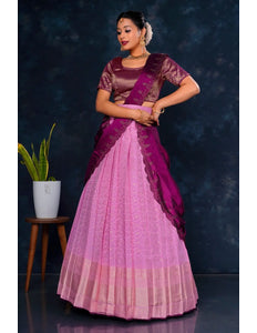 Woman wearing a pink and purple lehenga choli with dupatta