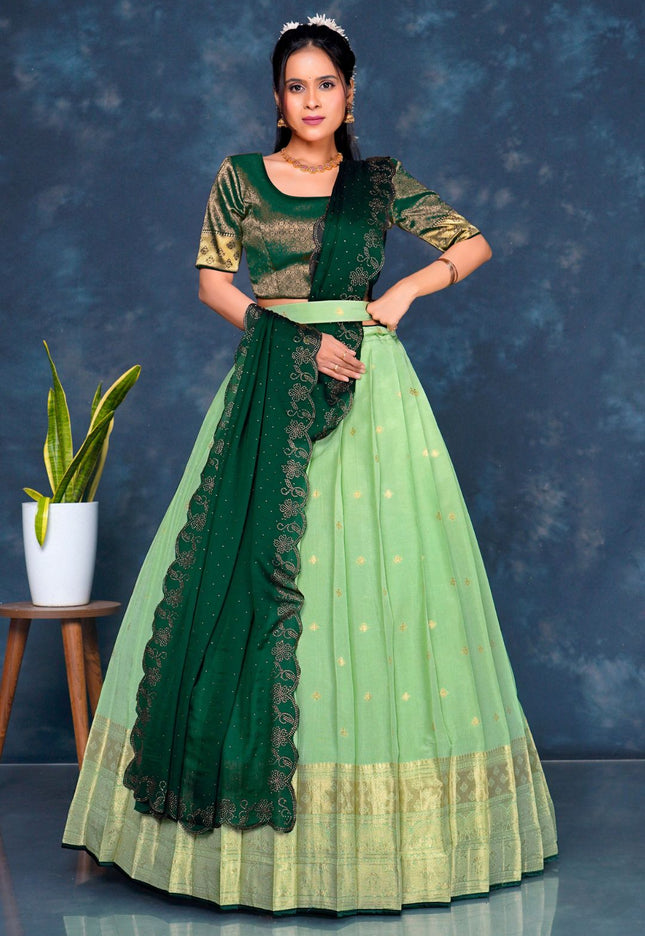 Woman wearing a green and light green traditional lehenga choli with dupatta