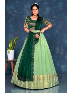 Woman wearing a green and light green traditional lehenga choli with dupatta