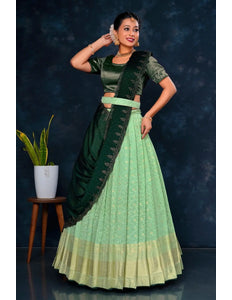 Woman in a green and light green traditional lehenga choli with dupatta