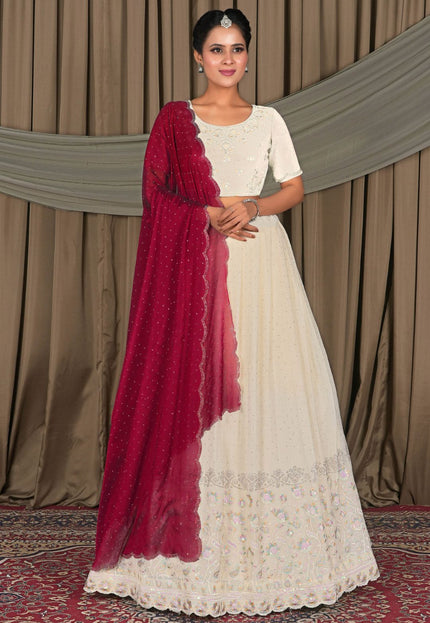 Woman in a white dress with a red shawl