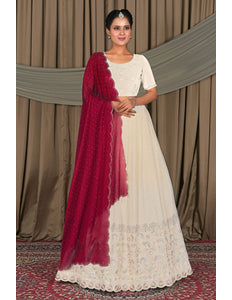 Woman in a white dress with a red shawl
