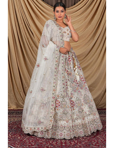 Woman wearing a traditional white embroidered outfit