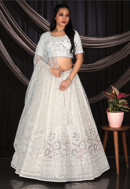 Woman in a white embroidered lehenga Choli