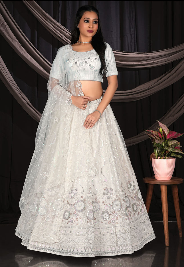 Woman in a white embroidered lehenga Choli