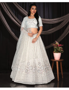 Woman in a white embroidered lehenga Choli