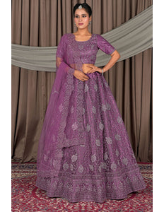 Woman wearing a purple embroidered traditional outfit