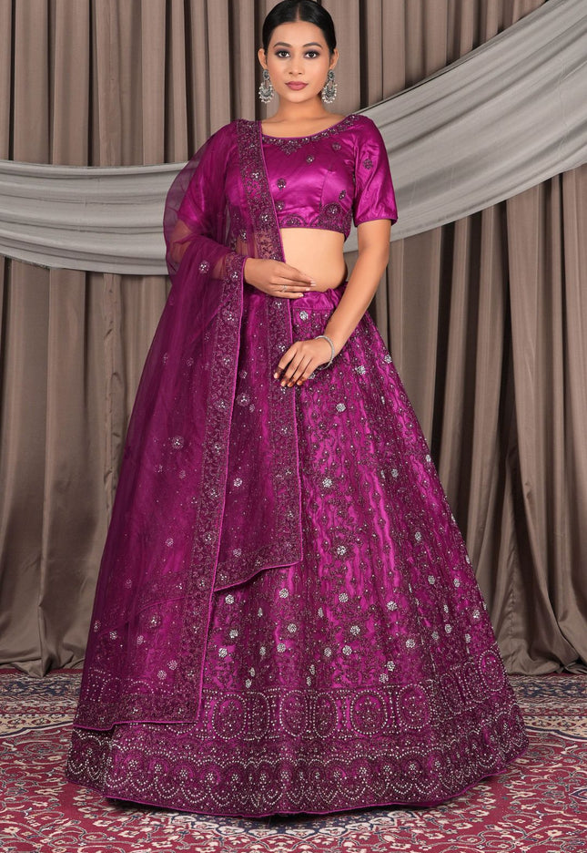 Woman wearing a vibrant purple traditional outfit with intricate designs