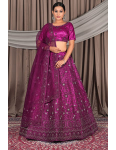 Woman wearing a vibrant purple traditional outfit with intricate designs