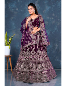 Woman wearing a traditional purple embroidered lehenga choli with dupatta