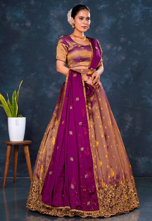 Woman wearing a traditional purple and gold lehenga choli with dupatta