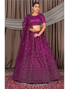 Woman wearing a purple traditional outfit with a patterned design
