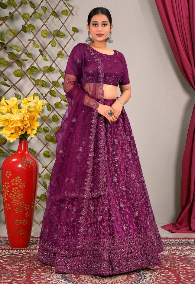 Woman wearing a purple embroidered traditional lehenga choli with matching dupatta