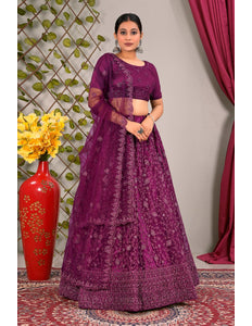Woman wearing a purple embroidered traditional lehenga choli with matching dupatta