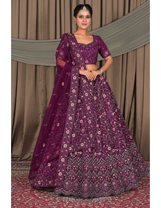 Woman wearing a purple traditional outfit with floral patterns