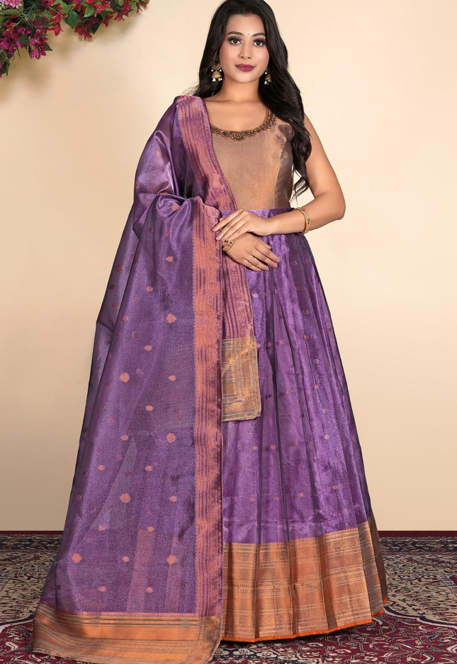 Woman wearing a traditional purple gown with a gold border